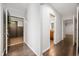 Hallway with wood flooring, fresh paint, and doorways to different rooms at 110 Washington St # 301, Indianapolis, IN 46204