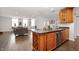 Open concept kitchen with wooden cabinets, granite countertops, and stainless steel appliances at 110 Washington St # 301, Indianapolis, IN 46204