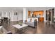 Open-concept living room with hardwood floors, modern furnishings, and an adjacent kitchen at 110 Washington St # 301, Indianapolis, IN 46204