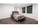 Cozy main bedroom featuring a comfortable bed, bedside lamps, and a stylish bench for added convenience at 110 Washington St # 301, Indianapolis, IN 46204