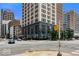 Exterior view of a tall building at an intersection with traffic and city life at 110 Washington St # 301, Indianapolis, IN 46204