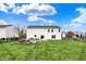 Large, grassy backyard with a stone patio, outdoor furniture and a stacked woodpile at 11631 Tamarisk Blvd, Fishers, IN 46037