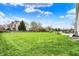 Spacious backyard with lush green grass, landscaping, and an outdoor patio area, ideal for gatherings at 11631 Tamarisk Blvd, Fishers, IN 46037