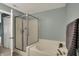 A large tub and shower combination creates a space to relax and refresh in this well lit bathroom at 11631 Tamarisk Blvd, Fishers, IN 46037