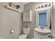 Charming half-bathroom features a classic vanity, decorative mirror and fresh paint at 11631 Tamarisk Blvd, Fishers, IN 46037