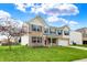 Attractive two-story brick home with blue shutters, mature trees, and an attached two-car garage at 11631 Tamarisk Blvd, Fishers, IN 46037