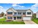 Stately two-story brick home featuring blue shutters, an attached garage, and a well-kept lawn at 11631 Tamarisk Blvd, Fishers, IN 46037