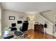 Well-lit home office with hardwood floors, multiple monitors and a view of the backyard at 11631 Tamarisk Blvd, Fishers, IN 46037