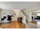 Spacious home office with hardwood floors, glass desk, neutral walls and stairway access at 11631 Tamarisk Blvd, Fishers, IN 46037