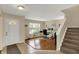 Bright home office with hardwood floors, glass desk, large window and a white entry door at 11631 Tamarisk Blvd, Fishers, IN 46037