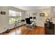Inviting home office with hardwood floors, a large window, and a modern glass desk at 11631 Tamarisk Blvd, Fishers, IN 46037