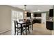 Eat-in kitchen with dark wood cabinets, tile backsplash, and stainless steel appliances at 11631 Tamarisk Blvd, Fishers, IN 46037