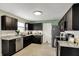 Modern kitchen features stainless steel appliances, granite countertops, and ample cabinet space at 11631 Tamarisk Blvd, Fishers, IN 46037