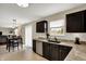 Open kitchen with stainless steel dishwasher and sink overlooking the dining area and backyard at 11631 Tamarisk Blvd, Fishers, IN 46037