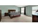 Spacious main bedroom with large windows, plush carpet, and complemented by neutral tones and dark wood furnishings at 11631 Tamarisk Blvd, Fishers, IN 46037