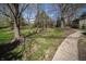 Property's expansive backyard with mature trees and stone walkway at 130 Governors Ln, Zionsville, IN 46077