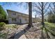Mature tree backyard with stone and brick elevation, and multi-pane windows at 130 Governors Ln, Zionsville, IN 46077