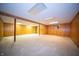 Unfinished basement space with wood paneled walls and a concrete floor at 130 Governors Ln, Zionsville, IN 46077