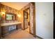 Vanity room with a vanity and a doorway to another room with floral wallpaper at 130 Governors Ln, Zionsville, IN 46077