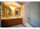 Charming bathroom featuring dual sinks, floral wallpaper, and a shower/tub combo at 130 Governors Ln, Zionsville, IN 46077