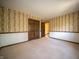 Carpeted bedroom featuring paneled walls, white base trim and a double door closet at 130 Governors Ln, Zionsville, IN 46077