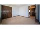 Bedroom with blue walls, carpet, closet, and a dark brown door at 130 Governors Ln, Zionsville, IN 46077