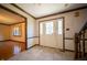 Inviting home foyer with tile flooring, decorative front door, and staircase at 130 Governors Ln, Zionsville, IN 46077