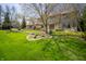 Charming stone-clad home with manicured lawn and mature trees creates inviting curb appeal at 130 Governors Ln, Zionsville, IN 46077