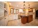 Well-lit kitchen featuring granite countertops, white cabinets, and an island at 130 Governors Ln, Zionsville, IN 46077