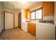 Bright laundry room features tile flooring, updated appliances, cabinets, and natural light at 130 Governors Ln, Zionsville, IN 46077