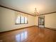 Spacious living room with hardwood floors, chandelier, and large window with curtains at 130 Governors Ln, Zionsville, IN 46077