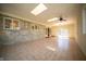 Open sunroom featuring natural stone wall, sliding glass door, tile flooring, and backyard views at 130 Governors Ln, Zionsville, IN 46077