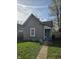 Cozy home featuring a neatly maintained lawn, mature trees, and neutral colored siding at 1343 W 33Rd St, Indianapolis, IN 46208
