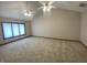 Spacious bedroom with neutral carpet and two ceiling fans with overhead lighting at 1394 Cherry Tree Rd, Avon, IN 46123