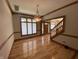 Dining room featuring wood floors and a chandelier with a view of the entryway and stairs at 1394 Cherry Tree Rd, Avon, IN 46123