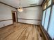 Dining room showcasing elegant chandelier, trim work, and hardwood floors next to a large window at 1394 Cherry Tree Rd, Avon, IN 46123
