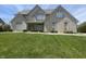 Traditional brick home with a lush green lawn and manicured landscaping in a suburban neighborhood at 1394 Cherry Tree Rd, Avon, IN 46123