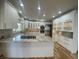Well-lit kitchen featuring a central island, granite countertops, stainless steel appliances, and white cabinetry at 1394 Cherry Tree Rd, Avon, IN 46123