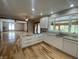 Open concept kitchen with granite island, stainless appliances, white cabinets, and hardwood floors at 1394 Cherry Tree Rd, Avon, IN 46123