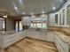 Bright kitchen boasts white cabinets, granite countertops, hardwood floors, and stainless steel appliances at 1394 Cherry Tree Rd, Avon, IN 46123