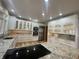 Spacious kitchen with stainless steel appliances, granite countertops, an island cooktop and ample cabinet space at 1394 Cherry Tree Rd, Avon, IN 46123