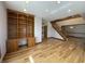 Living room with wood floors, built-in shelving, and an open layout leading to the staircase at 1394 Cherry Tree Rd, Avon, IN 46123