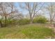 Spacious backyard, perfect for outdoor activities and relaxation, with mature trees and partial fencing at 14 Fountain Lake Dr, Greenfield, IN 46140