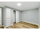 Bedroom showcasing a spacious closet and wood-look flooring for a modern, comfortable feel at 14 Fountain Lake Dr, Greenfield, IN 46140