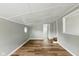 Comfortable bedroom space with wood flooring, natural light, and a view to other rooms through a window at 14 Fountain Lake Dr, Greenfield, IN 46140