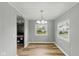 Bright dining room featuring modern lighting, wood floors, and a view of the well-maintained yard at 14 Fountain Lake Dr, Greenfield, IN 46140