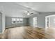 Bright living room featuring new wood flooring, neutral walls, and a ceiling fan for added comfort at 14 Fountain Lake Dr, Greenfield, IN 46140