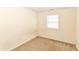 A bedroom with neutral walls, a window with blinds, and carpeted floor at 1414 Waldemere Ave, Indianapolis, IN 46241