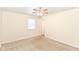 Comfortable bedroom features neutral carpet, a ceiling fan, a window, and closet, perfect for relaxation and personal space at 1414 Waldemere Ave, Indianapolis, IN 46241
