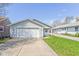 Charming single-story home features a two-car garage, well-maintained lawn, and traditional siding for a cozy curb appeal at 1414 Waldemere Ave, Indianapolis, IN 46241